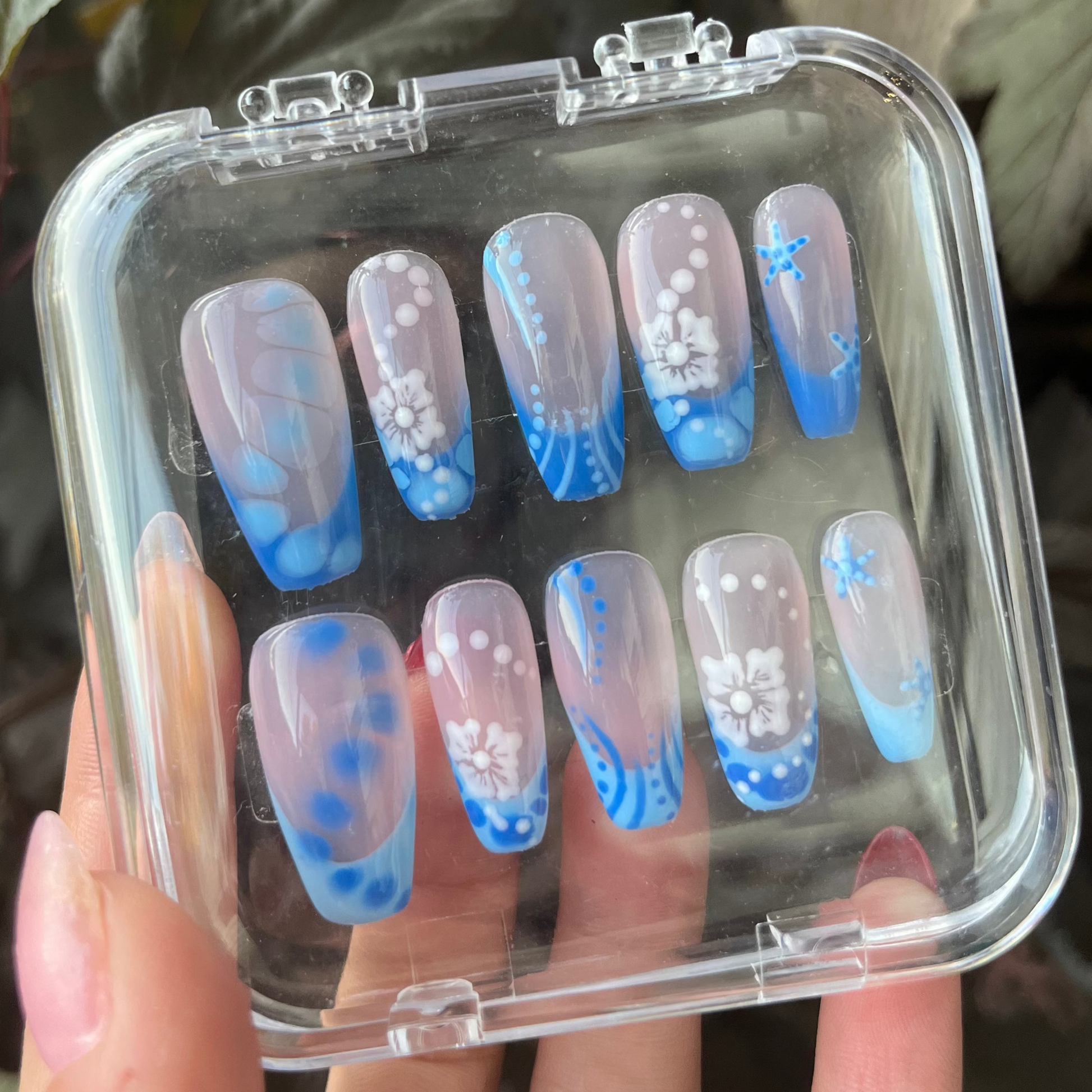 Set of blue vibes press-on nails with blue custom french tip. Flowers, sea stars, lines, dots and clear custom nail. 