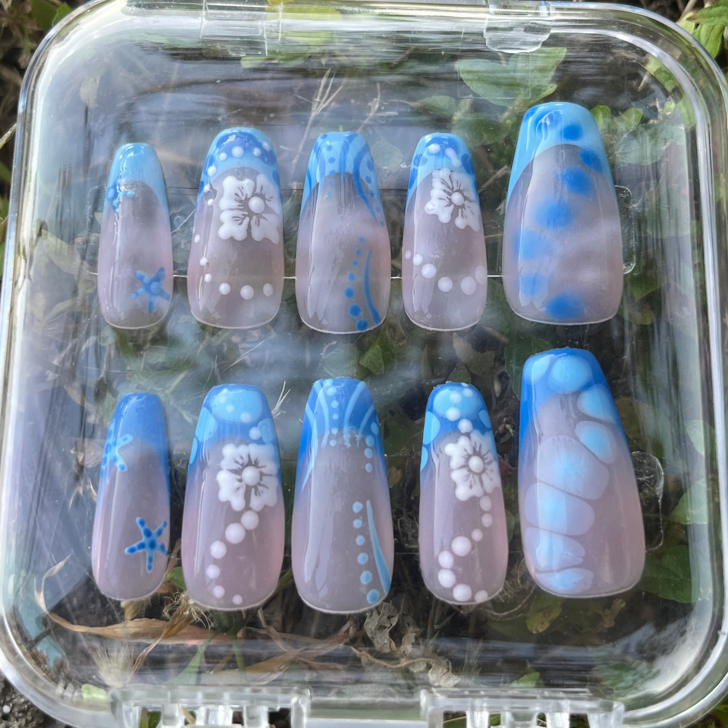 Set of blue vibes press-on nails with blue custom french tip. Flowers, sea stars, lines, dots and clear custom nail. 