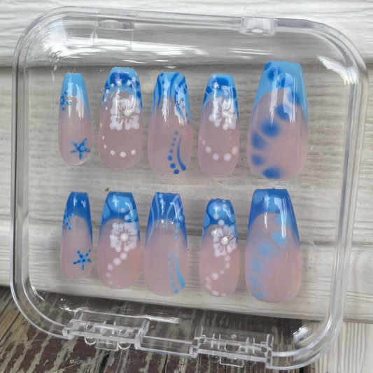 Set of blue vibes press-on nails with blue custom french tip. Flowers, sea stars, lines, dots and clear custom nail. 