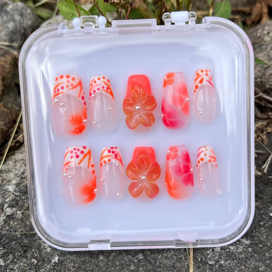 Set of orange vibes press-on nails with white custom french tip. 3d flower and clear custom nail.